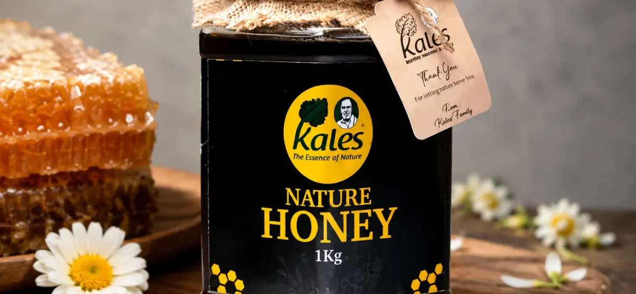 Buy Pure Honey Online in India – jar of pure honey with honeycomb and flowers